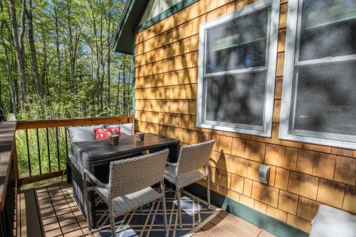 a patio with a table and chairs on a deck at Finley Lodge in Cooks Crossing