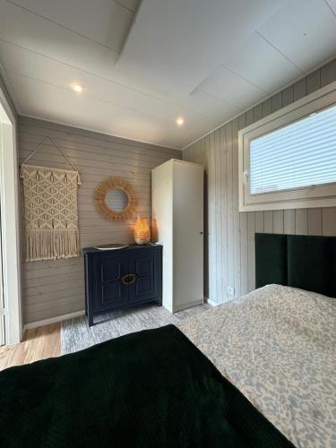 a bedroom with a large bed and a window at Domek Veli Stawinoga in Stawinoga