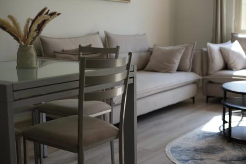 a living room with a table and a couch at Orikum Getaway in Orikum