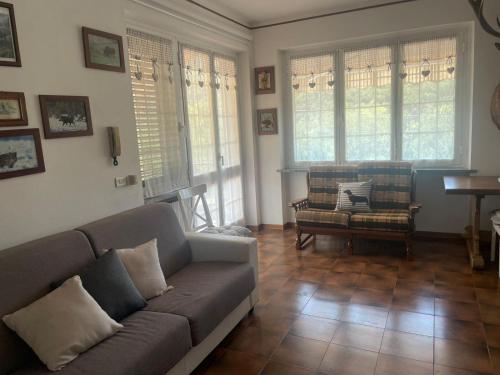 a living room with a couch and a chair at BassottHouse in Albera Ligure