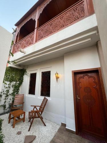 a pair of chairs sitting outside of a house at Royal Arabian Night in Marrakech