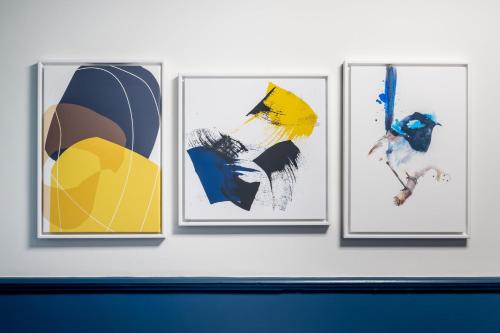a group of four pictures on a wall at voco London Marylebone by IHG in London