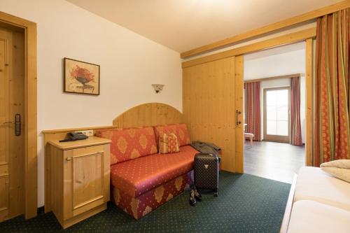 a hotel room with a couch in a room at Alpenkönig in Zell am Ziller