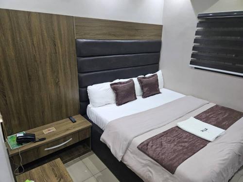 a hotel room with two beds and a table at We a in Port Harcourt