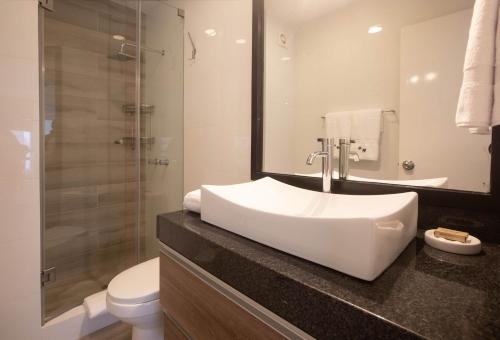 a bathroom with a sink and a toilet and a shower at Enlightening 1BR in Miraflores in Lima