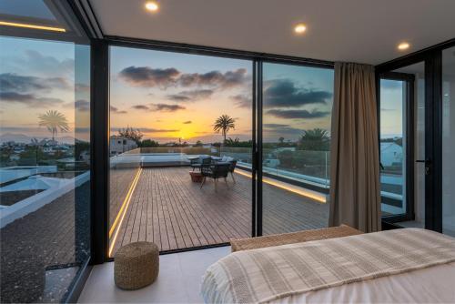 1 dormitorio con vistas a un balcón en Villa White Lava by Aura Collection, en Lajares
