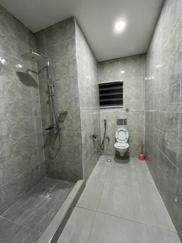 a bathroom with a shower and a toilet at Fancy Suites and Apartments Ltd in Abuja