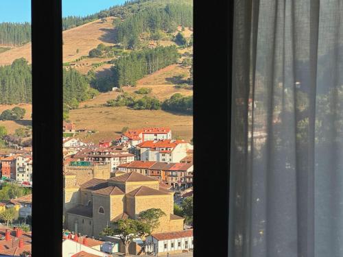 a view of a town from a window at El Balcón de Potes in Potes