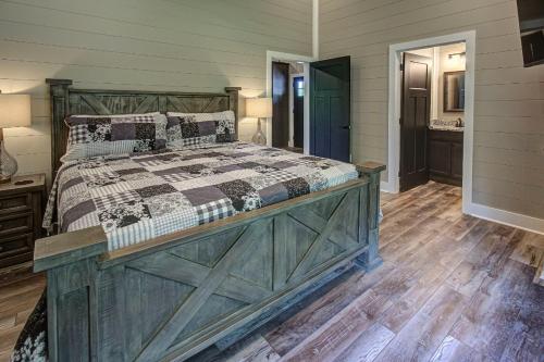 a bedroom with a large bed with a wooden headboard at Hilltop Haven By Avada Properties in Boyds Creek
