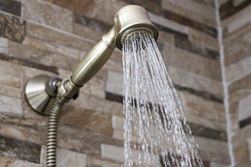 a shower head with water coming out of it at Picnic Dreams Boutique Hostel in Málaga
