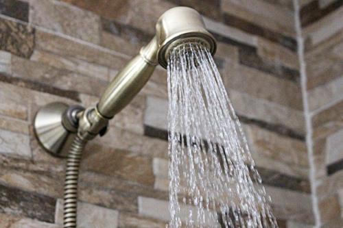 a shower head with water coming out of it at Picnic Dreams Boutique Hostel in Málaga