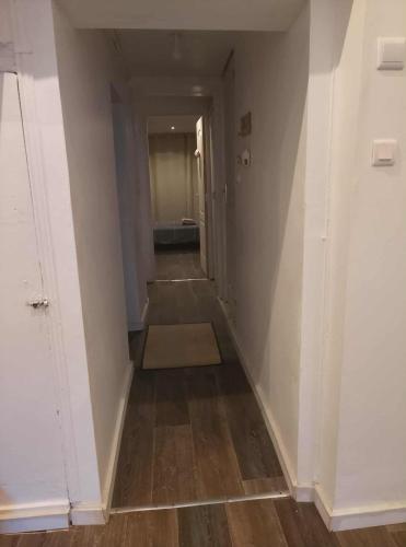 an empty hallway with a hallway leading into a room at Appartement entier 1 in Saint-Léonard-de-Noblat