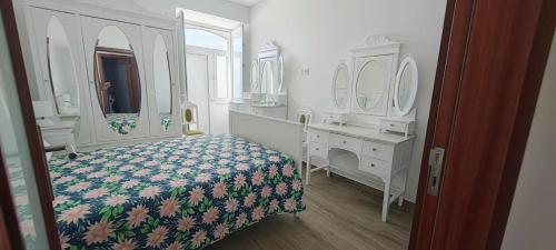 a bedroom with a bed and a dresser and mirror at Boa Passagem AL in Bicas