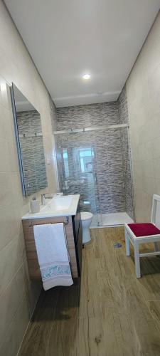 a bathroom with a sink and a shower and a toilet at Boa Passagem AL in Bicas