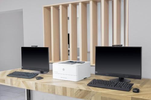 a desk with two computer monitors and a printer at TownePlace Suites Detroit Warren in Warren