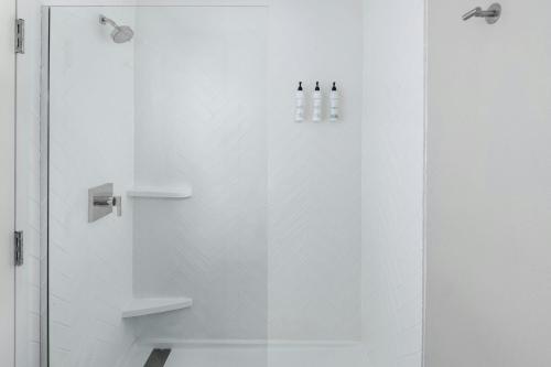a bathroom with a shower with a glass door at TownePlace Suites Detroit Warren in Warren