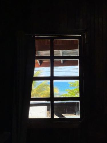 a window with a view of the sky through it at Hotel La Isla Inn in Puerto Viejo
