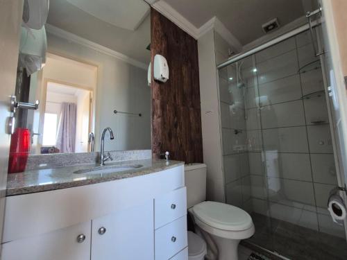 a bathroom with a sink and a toilet and a shower at 603 SEVILHA in Serra