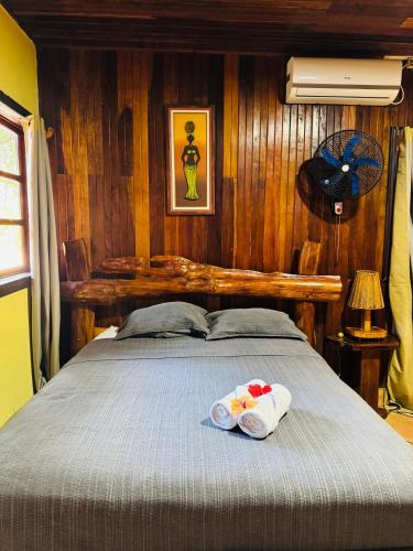 a bedroom with a bed with two towels on it at Hotel La Isla Inn in Puerto Viejo