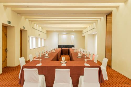 a long conference room with a long table and white chairs at Camino Real Monterrey in Monterrey