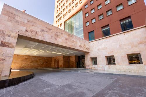 an external view of a large brick building with windows at Camino Real Monterrey in Monterrey