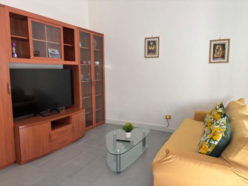 a living room with a couch and a flat screen tv at Tower casa vacanze in Anzio