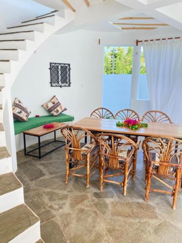 a dining room with a table and chairs at Banana House in Watamu
