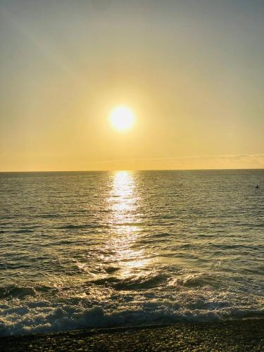 a sunset over the ocean with the sun setting at BEACH Arguineguin FIRST LINE 8 studio CHG FAMILY HOTEL in Arguineguín