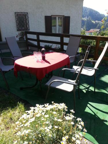 a red table and chairs on a patio at Ferienwohnung 2 Ferienhaus Gassner In Navis in Navis