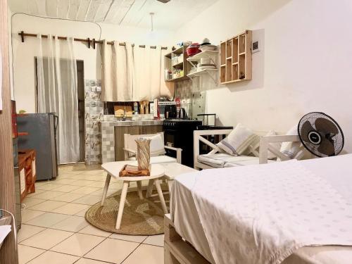 a living room with two beds and a kitchen at Nyumbani Studio in Ukunda Airport