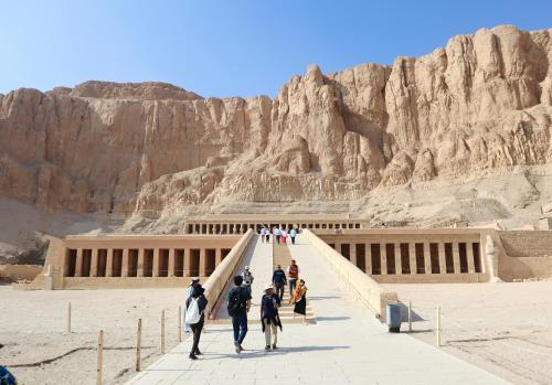 a group of people walking in front of a building at Bab Al Shams Palace in Luxor