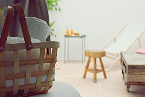 a wooden table with a basket on top of it at Picnic Dreams Boutique Hostel in Málaga