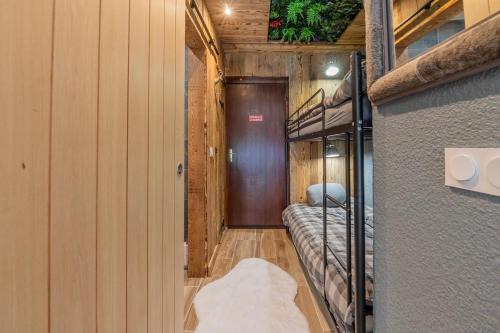 a hallway with bunk beds in a room at Chalet studio Megève enface des remontées mécaniques et parking gratuit in Demi-Quartier