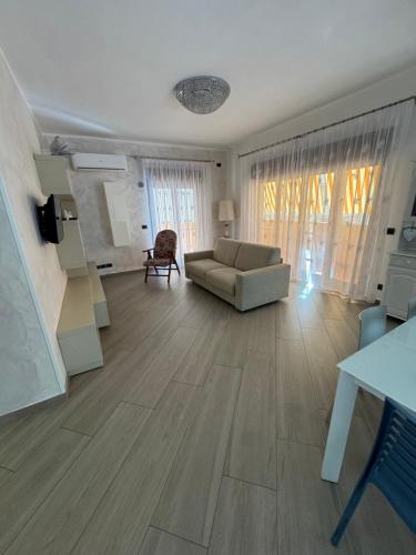 a living room with a couch and a table at Casamore in Villa San Giovanni