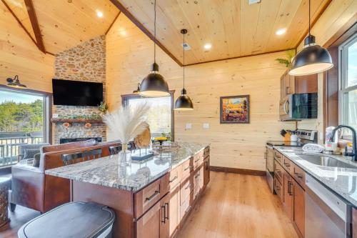 a kitchen with wooden walls and wooden floors and a large island at Lakeside Bear Lodge in Sevierville