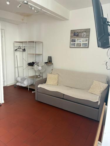 a living room with a couch and a table at Cocoon 3 - Studio bohème rénové Centre historique Beaucaire in Beaucaire