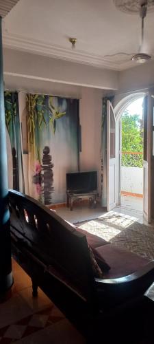 a living room with a couch and a piano at Villa Rose-Luxor in Luxor