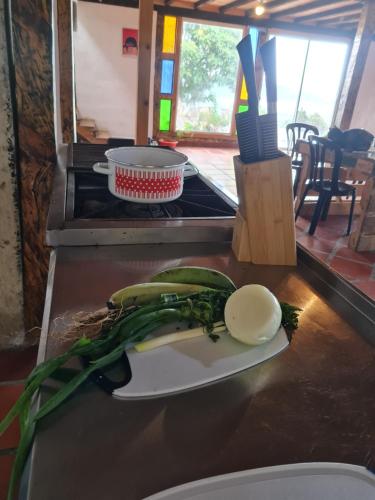 a counter with some vegetables on a cutting board at Chalet Montaña Tenjo Mirador in Tenjo