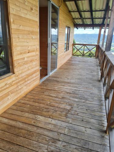 a wooden walkway leading to the front porch of a house at Chalet Montaña Tenjo Mirador in Tenjo