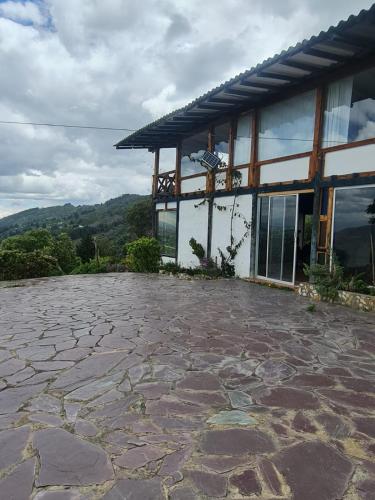 a stone patio in front of a building at Chalet Montaña Tenjo Mirador in Tenjo