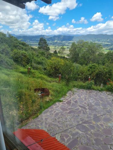 a view from a train window of a field with a view at Chalet Montaña Tenjo Mirador in Tenjo