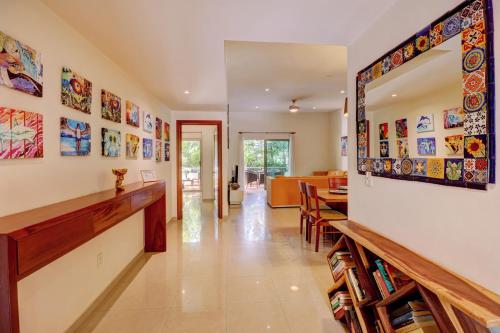 a living room with a large mirror on the wall at Palmar del Sol by Riviera Maya Suites in Playa del Carmen