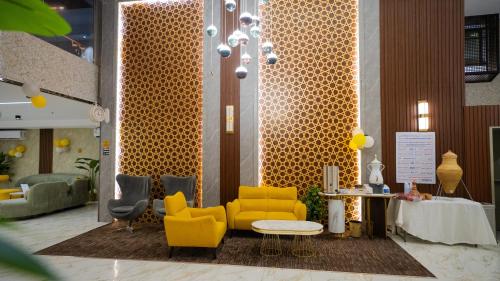 a lobby with two yellow chairs and a table at فندق يقين مكة in Makkah
