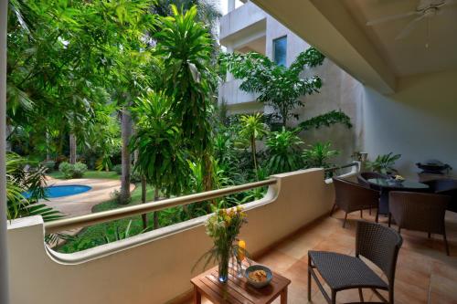 a balcony with a view of a garden at Palmar del Sol by Riviera Maya Suites in Playa del Carmen