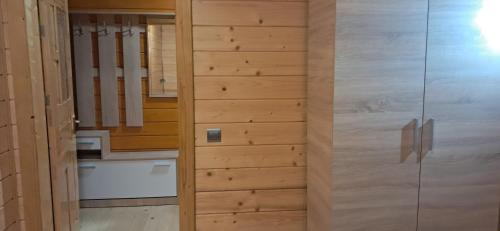 a wooden door in a room with a kitchen at Home comfort in Verkhovyna