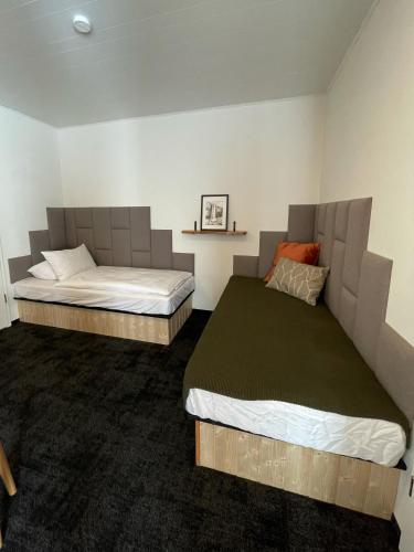 a room with two beds in a room at Amma Jóna rooms in Ásólfsskáli