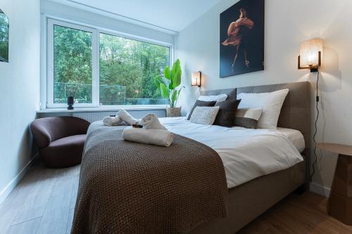 a bedroom with a large bed and a window at Affordable Private Room Near University Tilburg in Tilburg