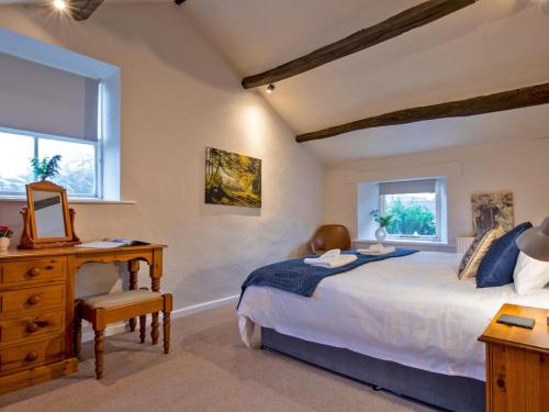 a bedroom with a large bed and a desk and window at 1 Bed in Hartington 90124 in Hartington