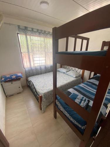 a bedroom with two bunk beds in a room at Finca Turística Las Margaritas in Rivera