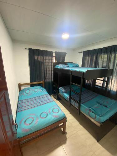 a room with two bunk beds and a table at Finca Turística Las Margaritas in Rivera